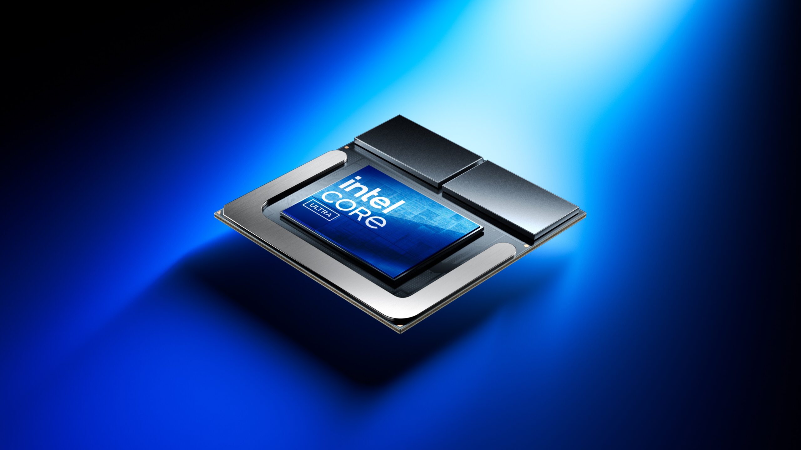 A computer processor labeled Intel Core sits on a reflective blue surface under a focused beam of light, emphasizing its sleek design and modern technology.