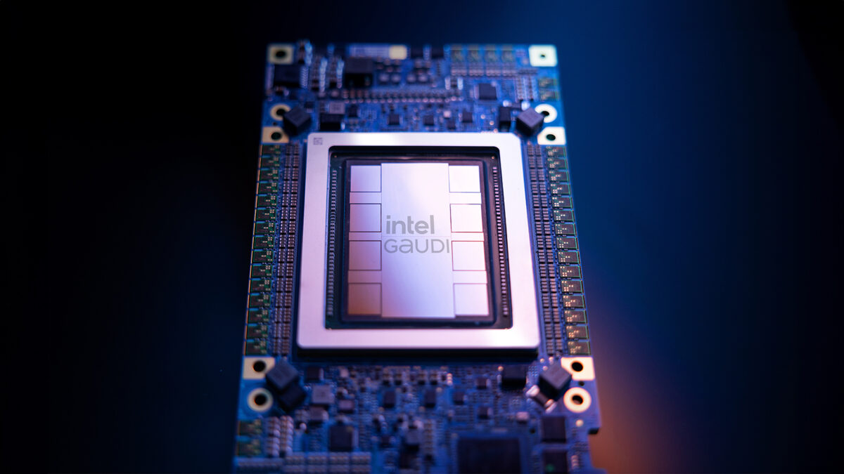 Close-up of a computer chip labeled Intel Gaudi on a circuit board, illuminated with a blue light.