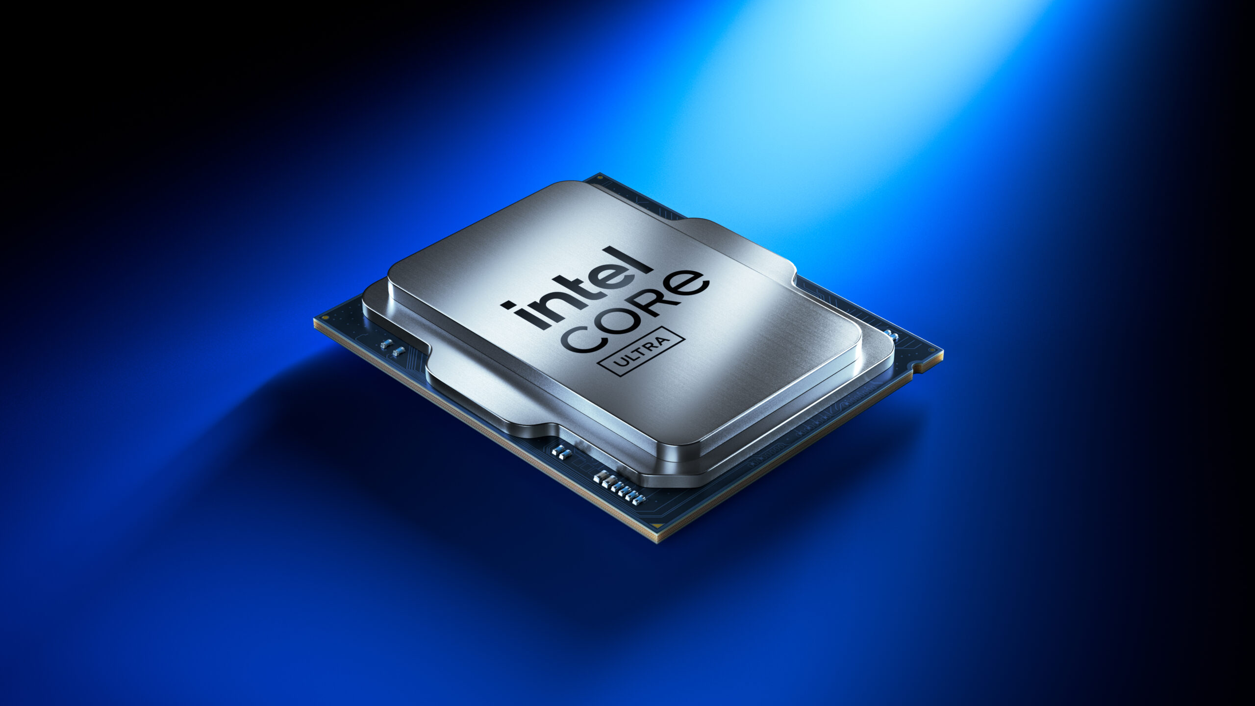 A close-up image of an Intel Core Ultra processor on a blue background, illuminated by a spotlight from above. The processor is metallic with the Intel logo and Ultra label visible on its surface.