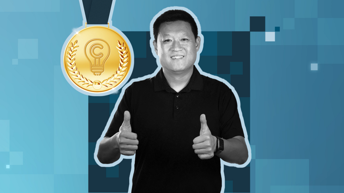 A person in a black shirt giving two thumbs up. A gold medal icon with a lightbulb and laurel design is shown in the top left. The background is a pixelated pattern in shades of blue.